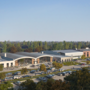 A large building with many cars parked in front of it.