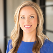 A woman with long blonde hair wearing blue.