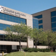 A large building with trees in front of it.