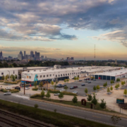 A view of a large warehouse complex with a train track.