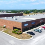 An aerial view of a building with cars parked in front.