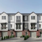 A row of houses with red brick and white trim.