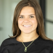 A woman with long hair wearing a black shirt.