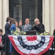 A group of people standing around a table.