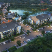 An aerial view of a residential area with cars parked on the side.