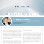 A person sitting in front of a building with the words " patterson capital views ".