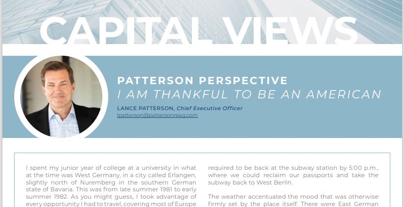 A person sitting in front of a building with the words " patterson capital views ".