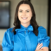 A woman in blue shirt with arms crossed.