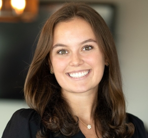 A woman with long hair smiles for the camera.